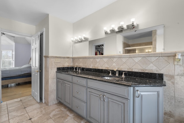 bathroom with tile walls, vanity, and tile patterned floors