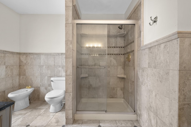 bathroom featuring toilet, an enclosed shower, tile walls, a bidet, and vanity