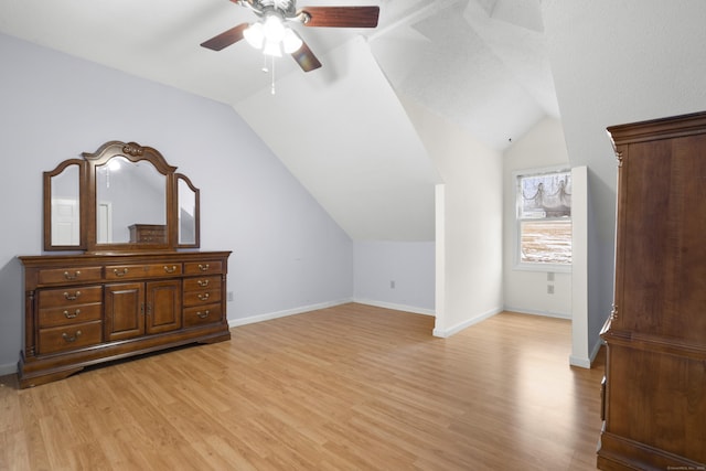 additional living space featuring vaulted ceiling, ceiling fan, and light hardwood / wood-style flooring