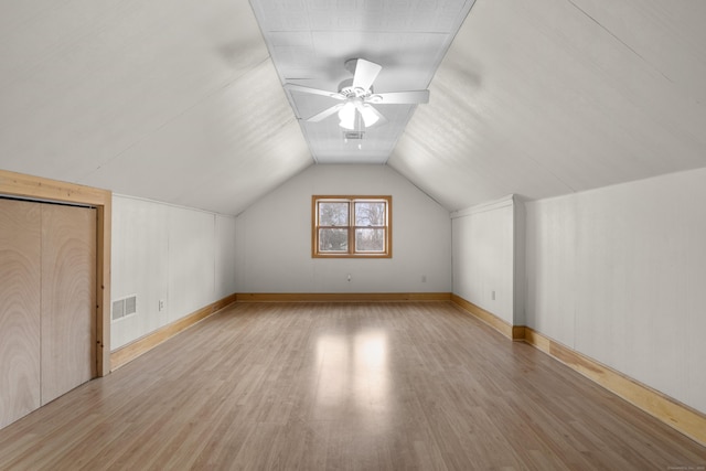 additional living space featuring lofted ceiling, ceiling fan, and light wood-type flooring