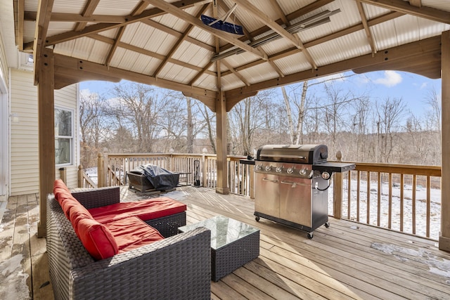 wooden deck featuring a gazebo, area for grilling, and an outdoor living space