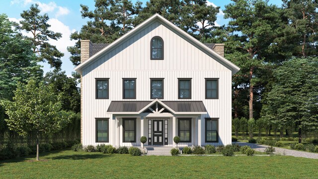 modern farmhouse style home with a front yard, a standing seam roof, covered porch, and a chimney