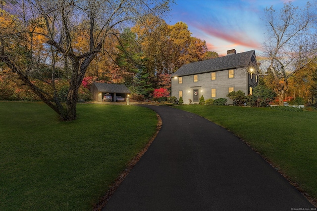 view of front of house featuring an outdoor structure and a lawn