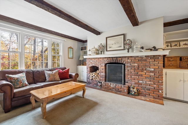 carpeted living room with beamed ceiling and a brick fireplace