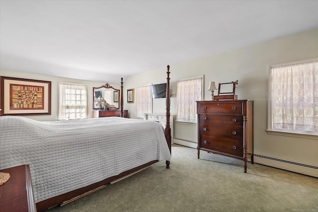 carpeted bedroom with a baseboard heating unit