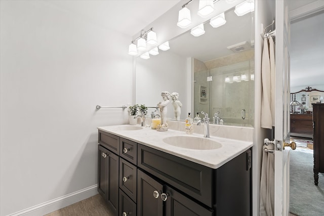 bathroom featuring an enclosed shower and vanity