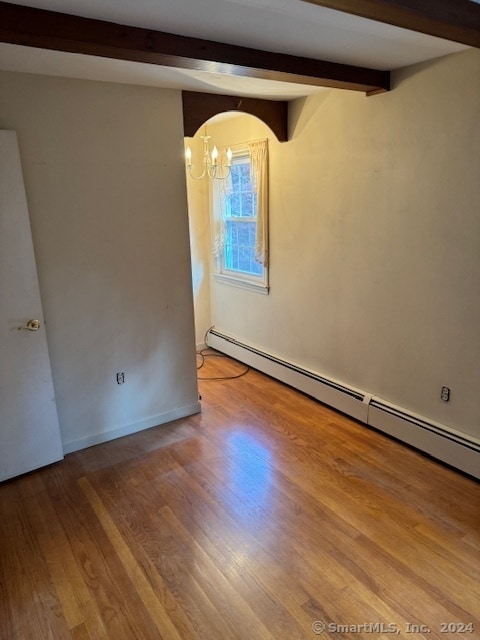 unfurnished room with beamed ceiling, a baseboard radiator, light hardwood / wood-style flooring, and an inviting chandelier