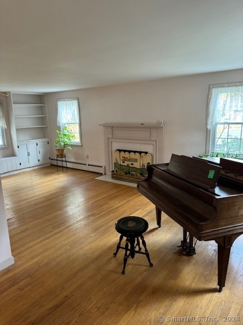 misc room featuring light hardwood / wood-style floors and a baseboard radiator