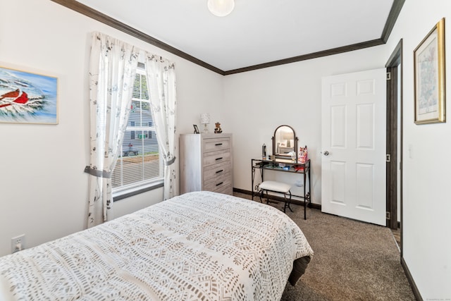 bedroom with ornamental molding and dark carpet