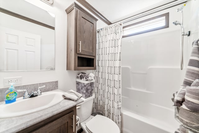 full bathroom featuring ornamental molding, vanity, toilet, and shower / tub combo with curtain