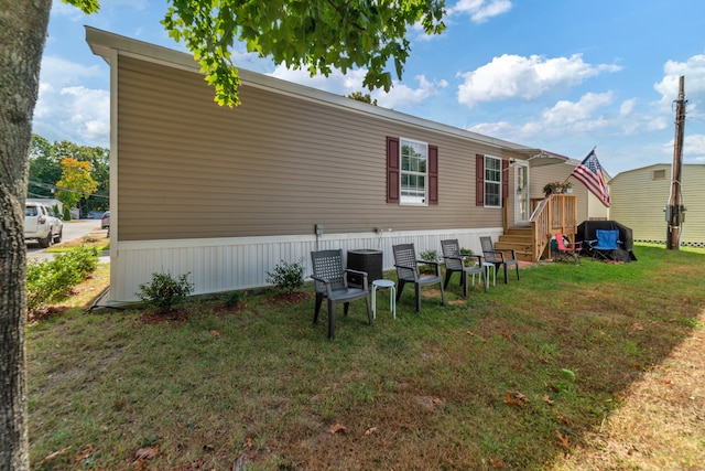 rear view of property featuring a lawn