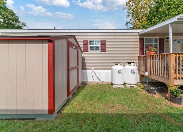 view of yard with a wooden deck and a shed