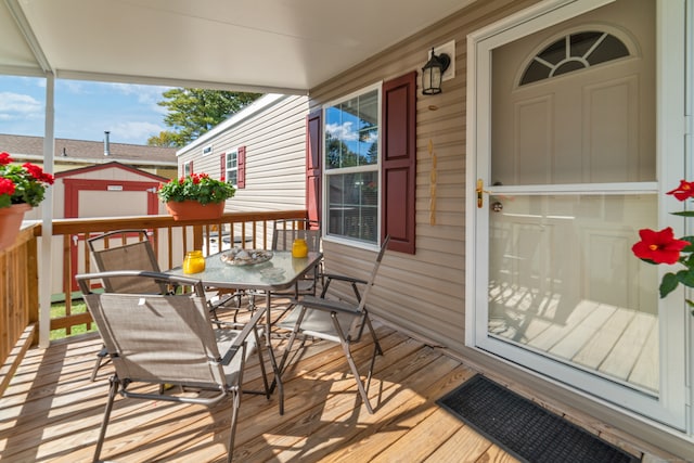 wooden deck featuring a shed