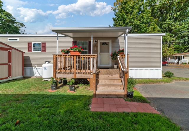 view of front facade with a storage unit and a front lawn