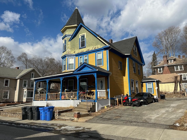 victorian-style house featuring covered porch