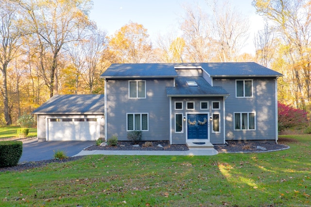 view of front of home featuring a front yard and a garage