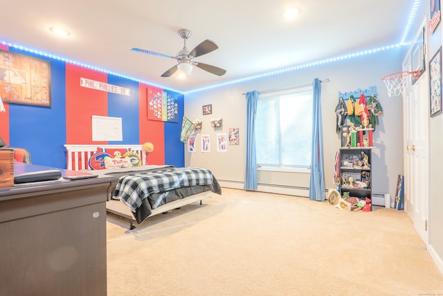 carpeted bedroom with a baseboard heating unit and ceiling fan