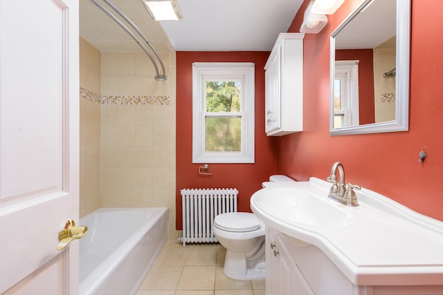 full bathroom featuring tile patterned flooring, toilet, radiator, tiled shower / bath, and vanity