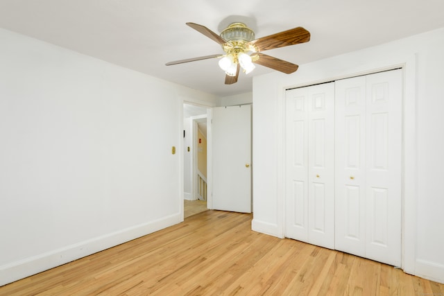 unfurnished bedroom with a closet, light wood-type flooring, and ceiling fan