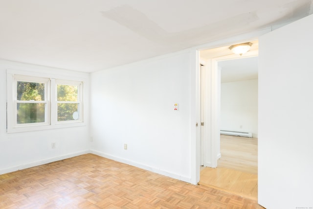 unfurnished room featuring light parquet flooring and baseboard heating