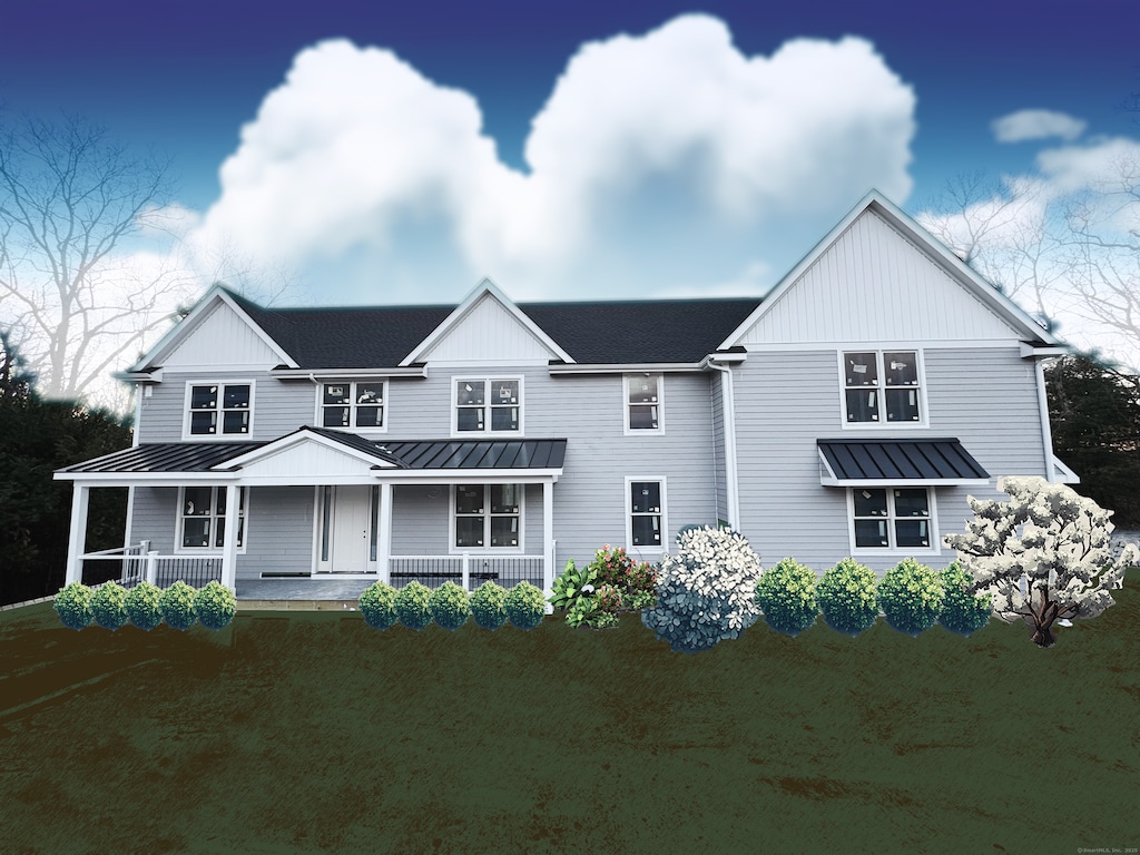 view of front of property with a standing seam roof, metal roof, covered porch, and roof with shingles