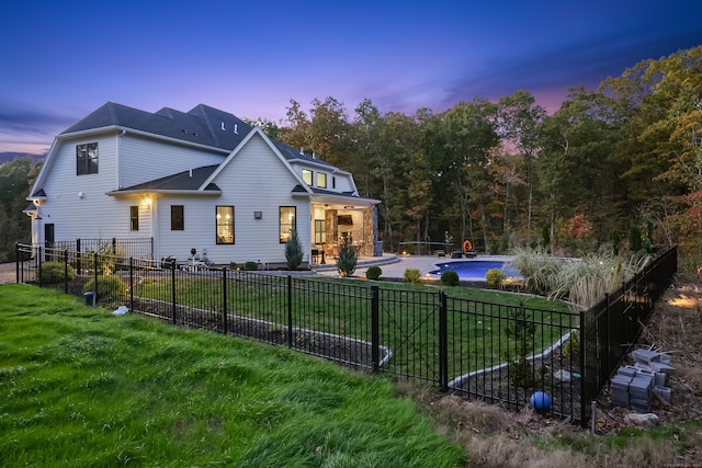 property exterior at dusk featuring a yard