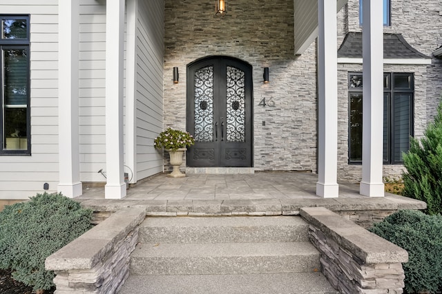 property entrance with french doors and covered porch