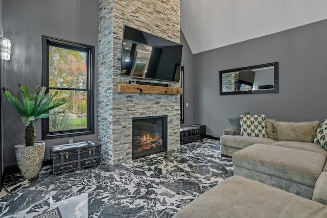 living room with a stone fireplace and vaulted ceiling