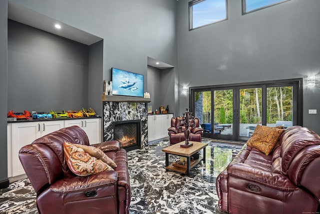 living room featuring a towering ceiling and a fireplace