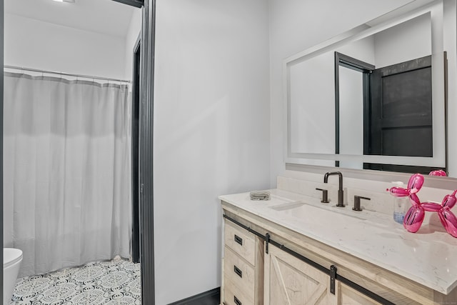 bathroom featuring vanity, toilet, and a shower with shower curtain