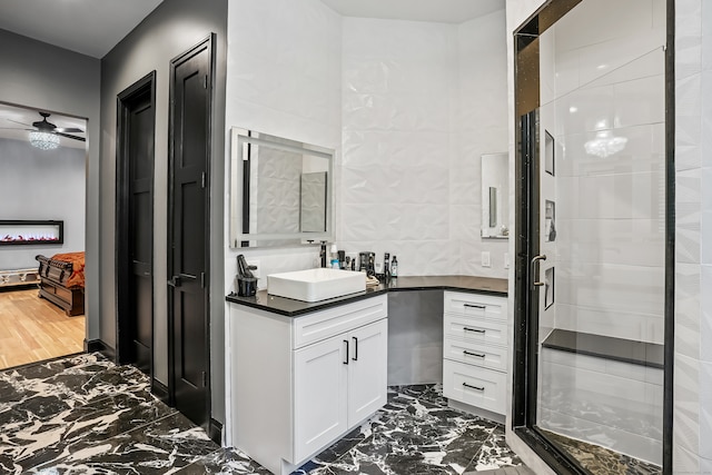 bathroom with ceiling fan, vanity, walk in shower, and wood-type flooring