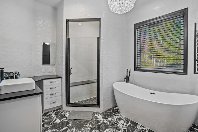 bathroom featuring vanity, tile walls, a chandelier, and plus walk in shower