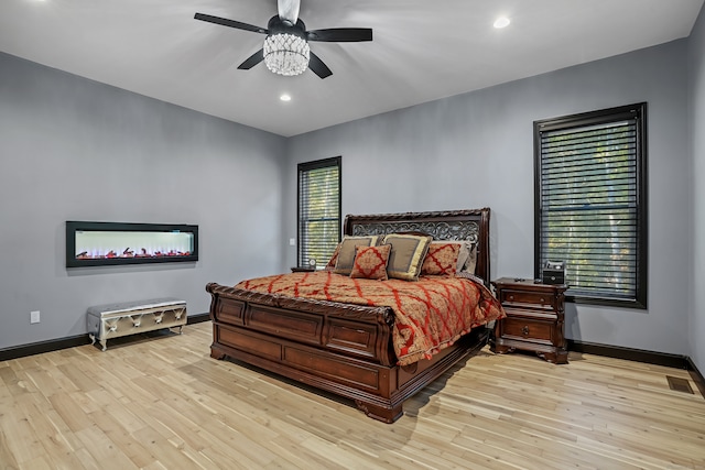 bedroom with ceiling fan and light hardwood / wood-style floors