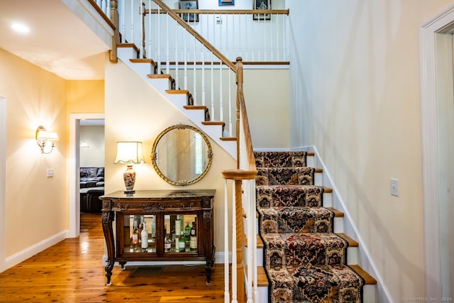 staircase featuring wood-type flooring