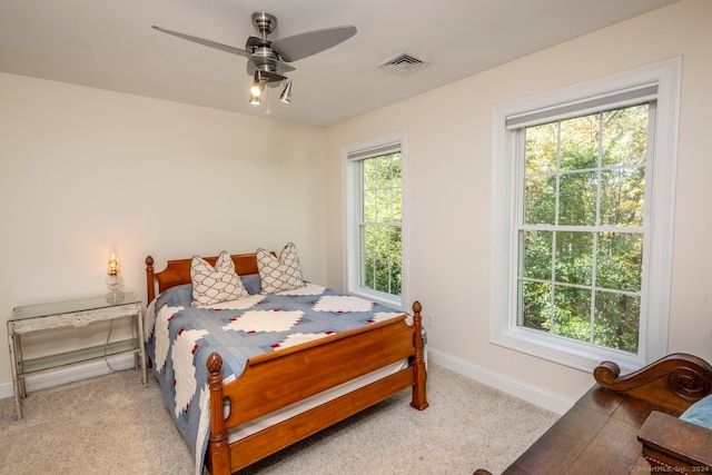 bedroom with light carpet and ceiling fan