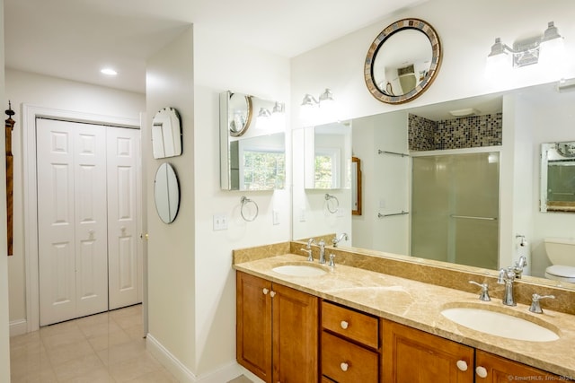 bathroom featuring tile patterned floors, vanity, walk in shower, and toilet