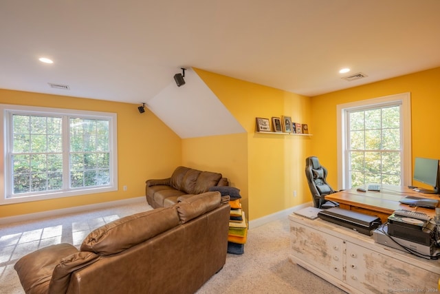 carpeted home office featuring vaulted ceiling