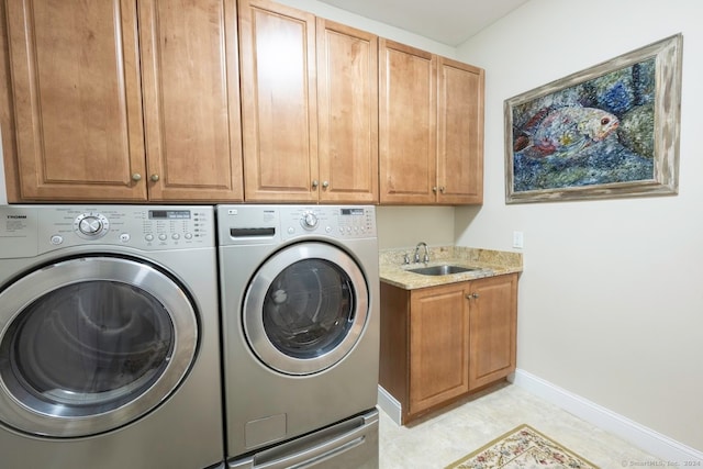 laundry room with separate washer and dryer, sink, and cabinets