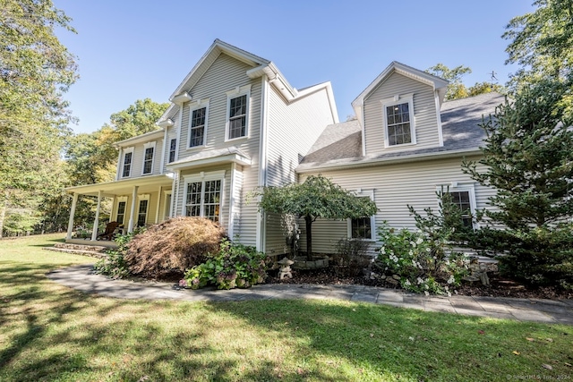 rear view of property with a yard