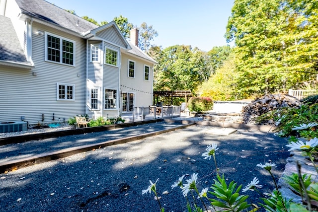 back of property featuring a wooden deck and central AC unit