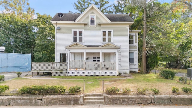 victorian home with a front lawn and covered porch