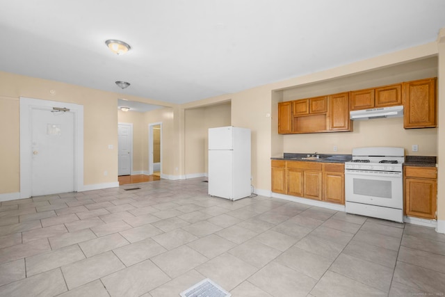 kitchen featuring light tile patterned floors, sink, and white appliances