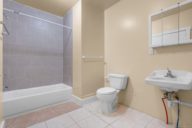 full bathroom with tiled shower / bath, sink, tile patterned flooring, and toilet