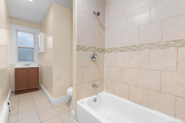 full bathroom featuring tile patterned flooring, tiled shower / bath, vanity, and toilet