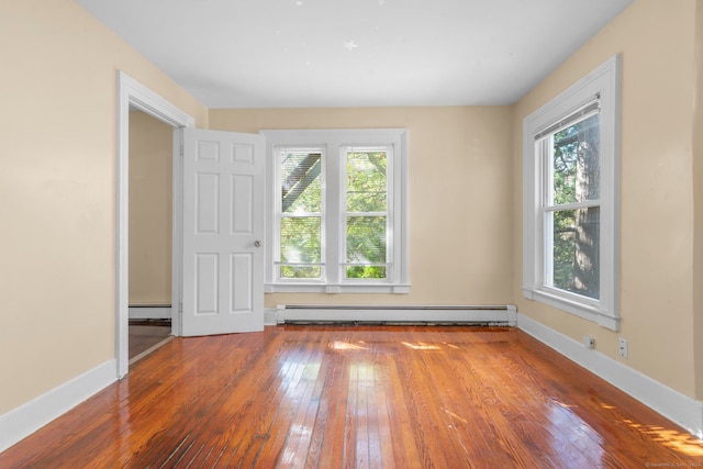 spare room with hardwood / wood-style flooring and baseboard heating