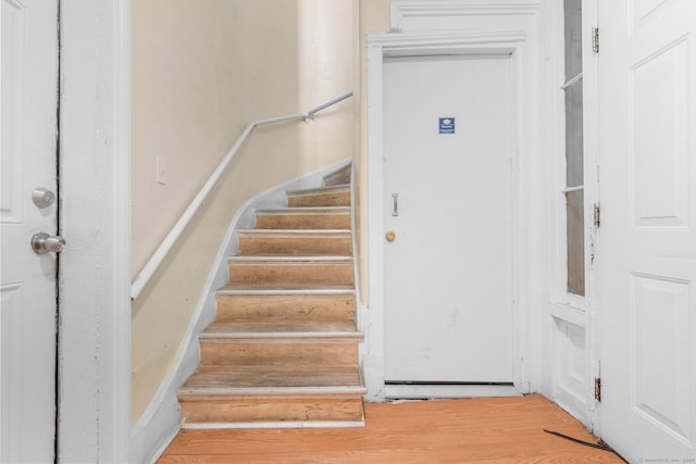 stairs with hardwood / wood-style flooring