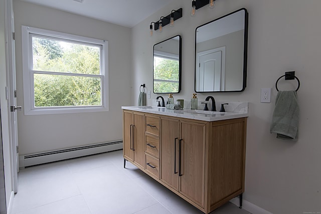 bathroom featuring vanity, tile patterned flooring, and baseboard heating