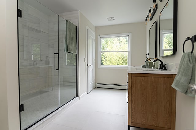 bathroom with a baseboard radiator, vanity, and an enclosed shower