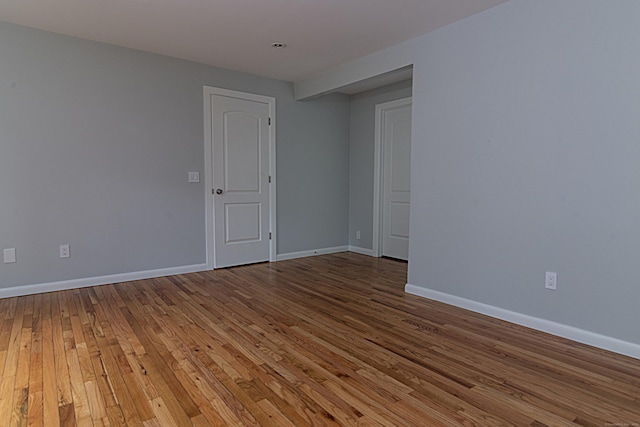 spare room with hardwood / wood-style floors