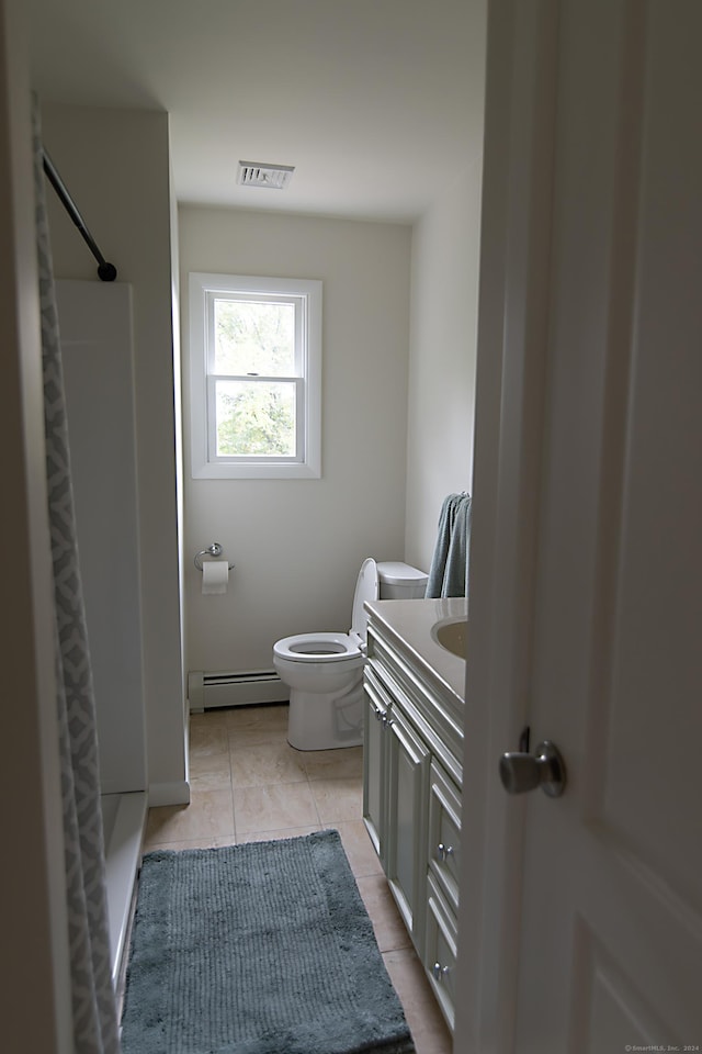 bathroom with a baseboard radiator, a shower, tile patterned flooring, vanity, and toilet